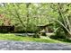 Single-story brick house with an inviting lawn, mature trees, and visible driveway at 6519 Creekside Ln, Indianapolis, IN 46220