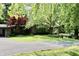 Charming single-story brick home with a well-manicured lawn, mature trees, and circular driveway at 6519 Creekside Ln, Indianapolis, IN 46220