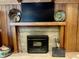 Wood-paneled fireplace with a mantelpiece, and decorative dishes at 6519 Creekside Ln, Indianapolis, IN 46220