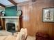 Close-up of a wood-paneled fireplace featuring a vintage-style at 6519 Creekside Ln, Indianapolis, IN 46220