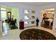 Spacious foyer features marble floors, round rug, and views into the living and dining areas at 6519 Creekside Ln, Indianapolis, IN 46220