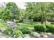 Charming exterior view of home showcasing a lush yard, mailbox, and mature trees at 6519 Creekside Ln, Indianapolis, IN 46220
