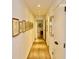 Bright hallway with hardwood floors and pictures hanging on the wall at 6519 Creekside Ln, Indianapolis, IN 46220