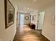 Hallway with hardwood floors, and decor including mirrors and artwork at 6519 Creekside Ln, Indianapolis, IN 46220