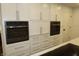 Kitchen featuring white cabinets, drawers, and stainless steel appliances, creating a clean, modern look at 6519 Creekside Ln, Indianapolis, IN 46220