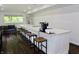 Bright open kitchen features white island with bar seating, modern appliances, and hardwood flooring at 6519 Creekside Ln, Indianapolis, IN 46220