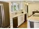 Renovated kitchen with stainless steel appliances, white marble countertops, and an undermount sink at 6519 Creekside Ln, Indianapolis, IN 46220