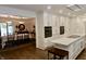 Well-lit open kitchen with white cabinetry, an island, and stainless steel appliances, flowing into the dining area at 6519 Creekside Ln, Indianapolis, IN 46220