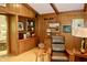 Inviting living room with wooden paneling, built-in shelving, and comfortable seating, creating a relaxing atmosphere at 6519 Creekside Ln, Indianapolis, IN 46220