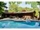 Inviting backyard oasis with pool, brick patio, and ample seating for outdoor entertaining at 6519 Creekside Ln, Indianapolis, IN 46220