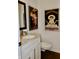 Stylish powder room with marble countertop, under-mount sink, and artistic decor at 6519 Creekside Ln, Indianapolis, IN 46220