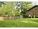 Well-manicured lawn with a wooden fence creating a private yard, perfect for outdoor enjoyment at 6519 Creekside Ln, Indianapolis, IN 46220