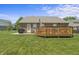 Lush backyard featuring a wooden deck, patio area, and a spacious lawn at 6529 Lakesedge Dr, Indianapolis, IN 46237