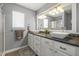 Bright bathroom showcasing dual vessel sinks, granite countertop, and a framed glass shower door at 6529 Lakesedge Dr, Indianapolis, IN 46237