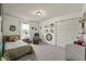 Neutral bedroom, decorated with books, a light and neutral theme, and a cozy rocking chair at 6529 Lakesedge Dr, Indianapolis, IN 46237