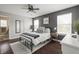Well-lit bedroom with wood floors, a decorative rug, and neutral colors, creating a serene space at 6529 Lakesedge Dr, Indianapolis, IN 46237