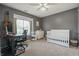 Bedroom offering a workspace, acoustic guitar, and a Bedroom section with white crib and changing table at 6529 Lakesedge Dr, Indianapolis, IN 46237
