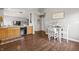 Open-concept dining room adjacent to the kitchen and Gathering room with hardwood floors at 6529 Lakesedge Dr, Indianapolis, IN 46237