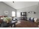 Well-lit living room highlighting hardwood floors, a ceiling fan, and a comfortable seating area for relaxation at 6529 Lakesedge Dr, Indianapolis, IN 46237
