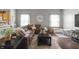 Cozy living room features hardwood floors, ample natural light, and a stylish brown leather sofa set at 6529 Lakesedge Dr, Indianapolis, IN 46237