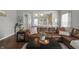 Open-concept living room showcases hardwood floors, a comfortable leather sofa, and stylish decor at 6529 Lakesedge Dr, Indianapolis, IN 46237