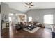Comfortable living room showcasing an open floor plan with hardwood floors and stylish brown leather sofa at 6529 Lakesedge Dr, Indianapolis, IN 46237