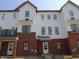 Modern townhome exterior featuring brick and white siding, and multiple windows at 7063 Pate Hollow Dr, Brownsburg, IN 46112