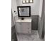 Stylish bathroom featuring a black framed mirror with a white vanity and marble tile flooring at 7492 Country Brook Dr, Indianapolis, IN 46260