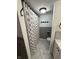 Cozy bathroom with marble floors, gray wainscotting, and a checkered shower curtain at 7492 Country Brook Dr, Indianapolis, IN 46260