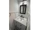 Charming bathroom featuring a white vanity with a marble countertop and a fancy ornate mirror at 7492 Country Brook Dr, Indianapolis, IN 46260