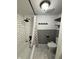 Relaxing bathroom featuring a tub with a shower, toilet, unique shelves, and gray wainscoting at 7492 Country Brook Dr, Indianapolis, IN 46260