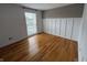 Bright bedroom with hardwood floors, white wainscoting, and a large window at 7492 Country Brook Dr, Indianapolis, IN 46260