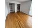 Bedroom featuring hardwood floors and shelving in closet at 7492 Country Brook Dr, Indianapolis, IN 46260