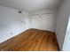 A clean, bright bedroom with hardwood floors and double closets at 7492 Country Brook Dr, Indianapolis, IN 46260