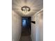 Hallway with hardwood floors and an elegant crystal light fixture at 7492 Country Brook Dr, Indianapolis, IN 46260