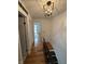 Hallway featuring hardwood floors and decorative light fixture at 7492 Country Brook Dr, Indianapolis, IN 46260