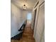 Hallway with hardwood floors, updated lighting, and convenient closet space at 7492 Country Brook Dr, Indianapolis, IN 46260