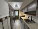 Galley kitchen with stainless steel appliances, granite countertops, and tiled backsplash at 7492 Country Brook Dr, Indianapolis, IN 46260