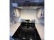 Stylish kitchen featuring stainless steel appliances, a modern range hood, and sleek countertops at 7492 Country Brook Dr, Indianapolis, IN 46260