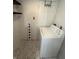 Functional laundry area with white washer, laundry sign, and marble flooring at 7492 Country Brook Dr, Indianapolis, IN 46260