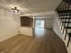 Open-concept living room with hardwood floors, modern lighting, and staircase at 7492 Country Brook Dr, Indianapolis, IN 46260