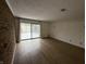 Inviting living room with wood floors, brick wall, and sliding glass doors leading to the outside at 7492 Country Brook Dr, Indianapolis, IN 46260