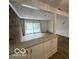 Spacious living area with brick wall and sliding glass doors to the backyard at 7492 Country Brook Dr, Indianapolis, IN 46260