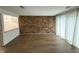 Bright living room featuring hardwood floors, exposed brick accent wall, and natural light at 7492 Country Brook Dr, Indianapolis, IN 46260
