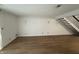 Spacious living room featuring hardwood floors, sconce lighting, and staircase at 7492 Country Brook Dr, Indianapolis, IN 46260