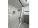 Stylish shower features white subway tile walls with a decorative mosaic inset and black fixtures at 7492 Country Brook Dr, Indianapolis, IN 46260