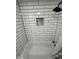 The shower features white subway tile walls with a decorative mosaic inset and black shower head at 7492 Country Brook Dr, Indianapolis, IN 46260