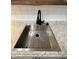 Close-up of a stainless steel kitchen sink with granite countertops and a modern black faucet at 7492 Country Brook Dr, Indianapolis, IN 46260
