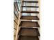 Stairs with carpet treads and a view of the hallway at 7492 Country Brook Dr, Indianapolis, IN 46260