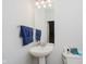 Half bathroom with pedestal sink and modern fixtures at 755 Ivy Ln, Carmel, IN 46032